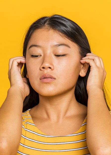 Woman holding her hair and looking down