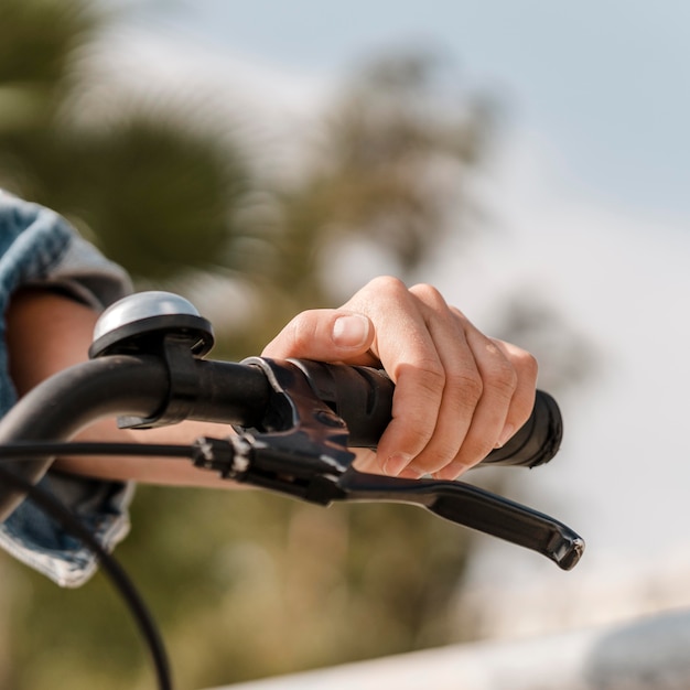 Woman holding her hand on a handlebar grip
