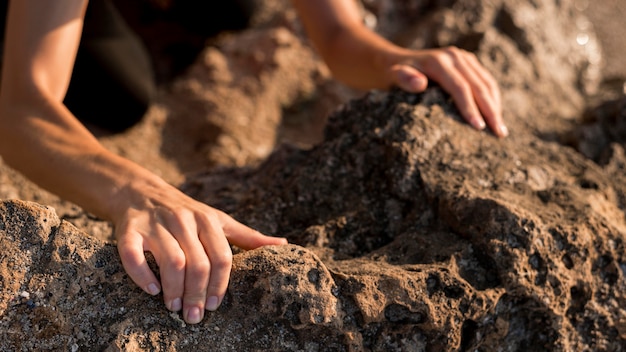 Woman holding her hands in the ground