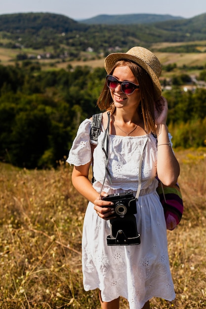 Woman holding her hat and looking away