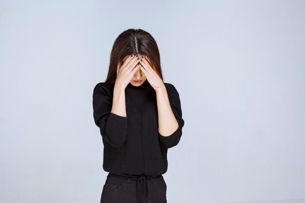 woman holding her head as she is tired or has headache. 