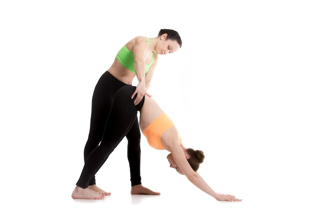 Woman holding hip to another woman