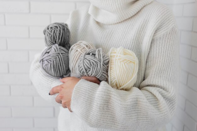 Woman holding knitting wool close up