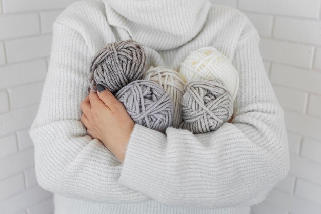 Woman holding knitting wool close up