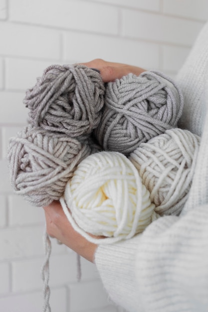 Woman holding knitting wool close up