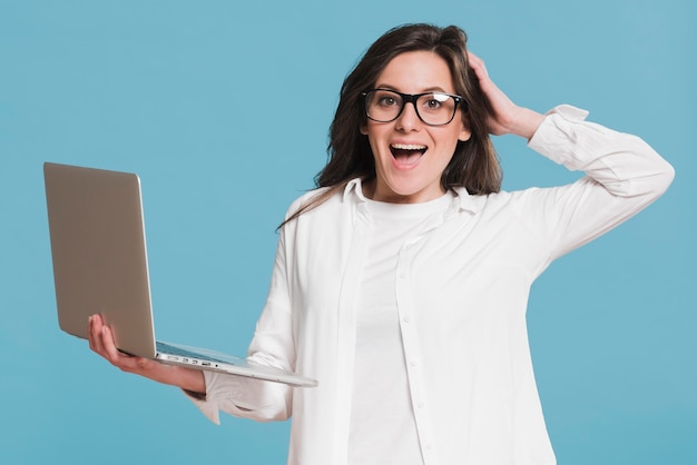 Woman holding laptop and being amazed