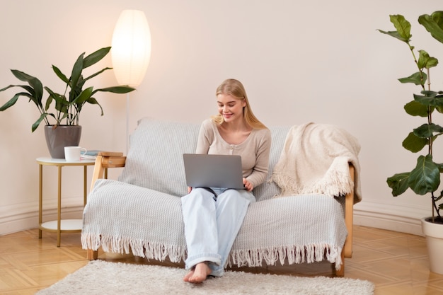 Woman holding laptop full shot