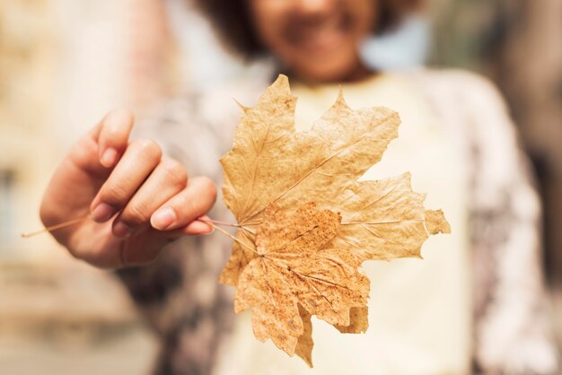 Woman holding a leaf close-up