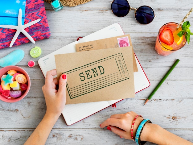 Woman holding letter with summer flat lay