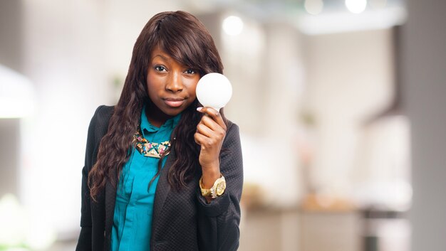 Woman holding a light bulb