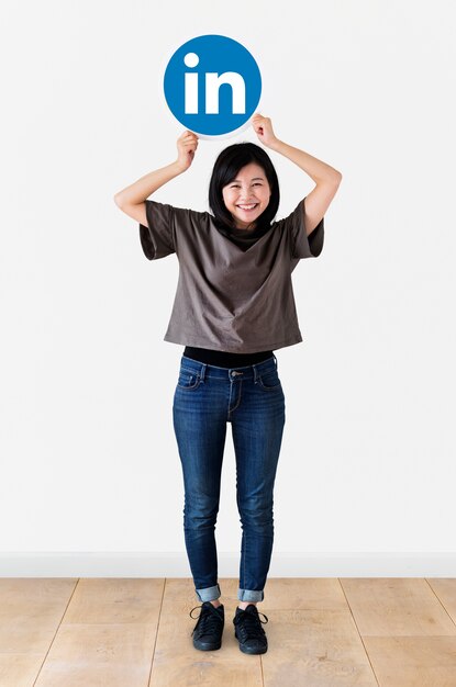 Woman holding a Linkedin icon