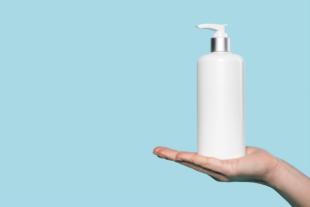 Woman holding a liquid soap bottle