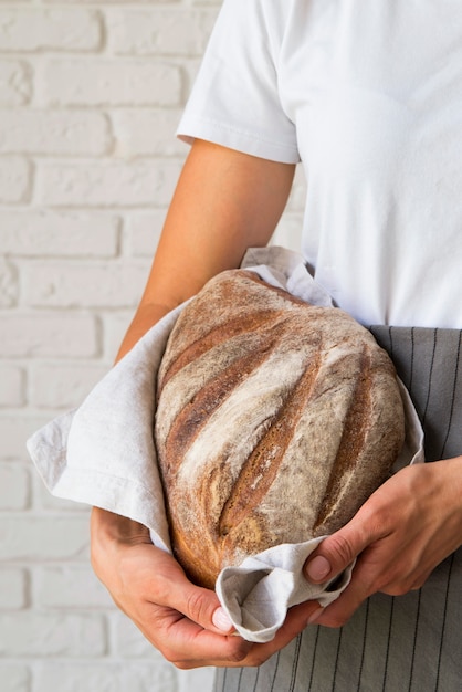 Woman holding loaf of bread