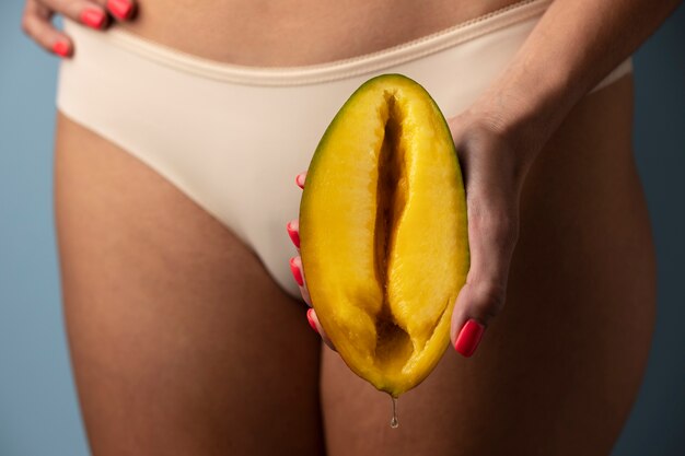 Woman holding mango front view