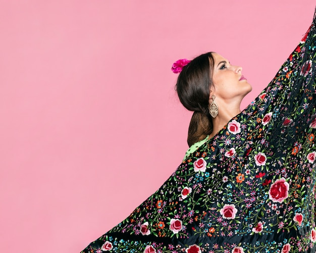 Woman holding manila shawl looking up