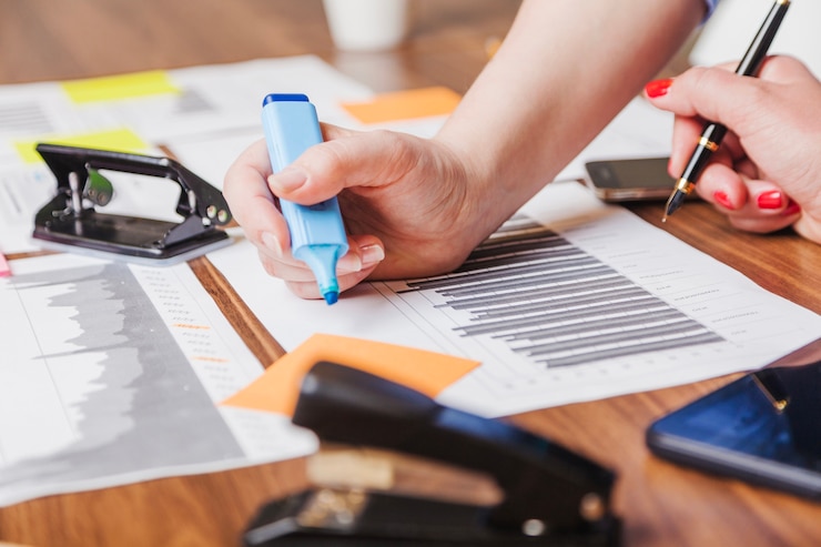 Free Photo woman holding marker pen leaning on desk