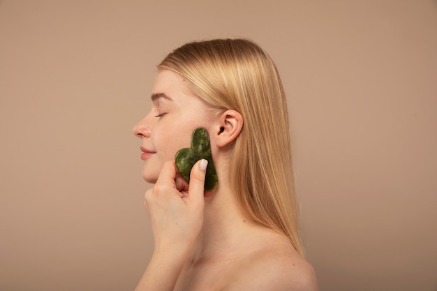 Woman holding massaging tool close up