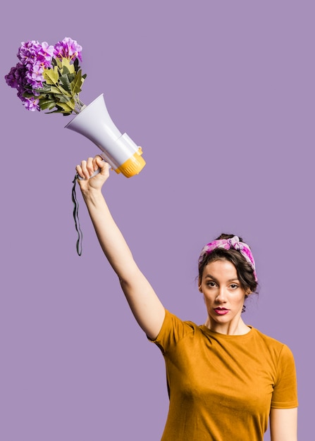 Woman holding megaphone and cardboard with "me too" sign