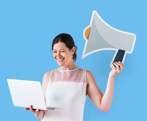 Woman holding a megaphone icon and using a laptop