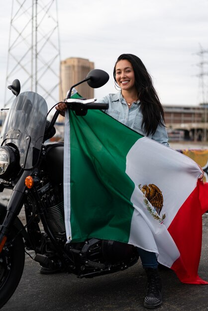 通りでメキシコの旗を保持している女性