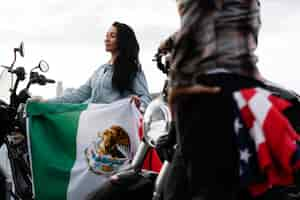 Free photo woman holding mexican flag in the street