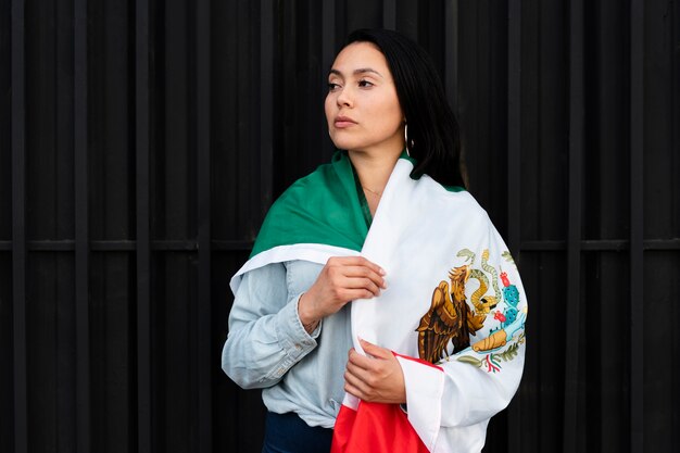 Woman holding mexican flag in the street