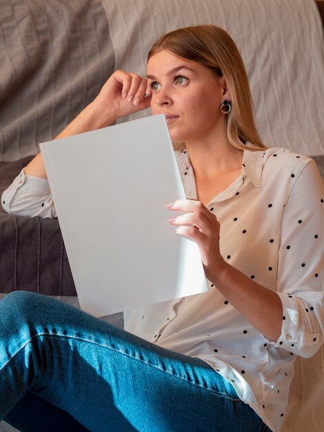 Woman holding a mock-up magazine