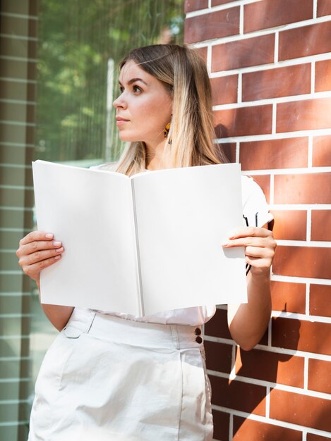 Woman holding a mock-up magazine