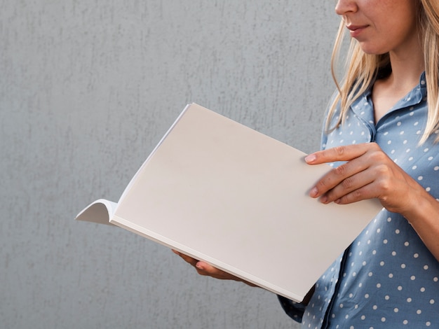 Woman holding a mock-up magazine