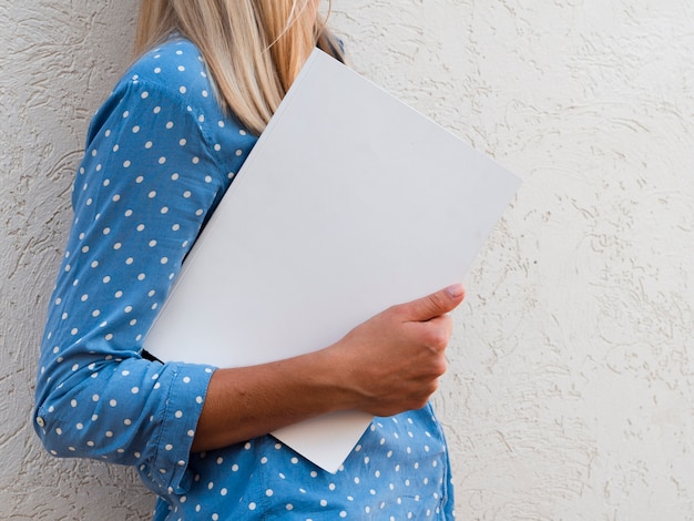 Woman holding a mock-up magazine