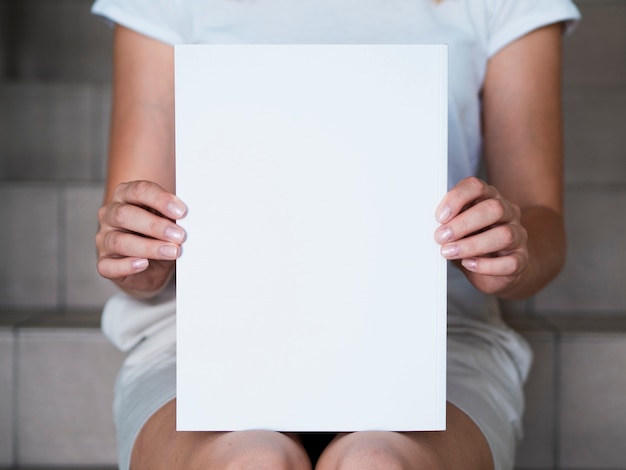 Woman holding a mock-up magazine