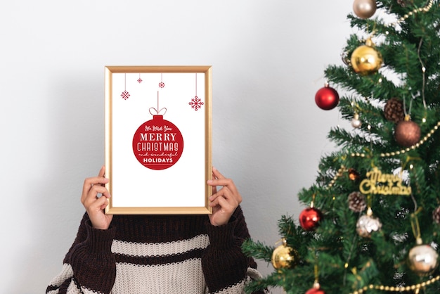 Woman holding mockup frame design for decoration Christmas day