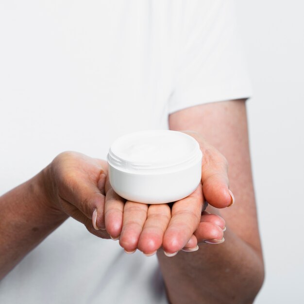 Woman holding moisturizer in hands