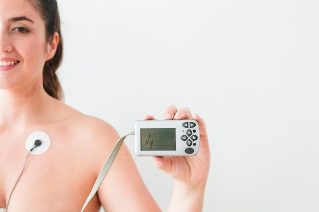 Free photo woman holding monitor with cardiogram