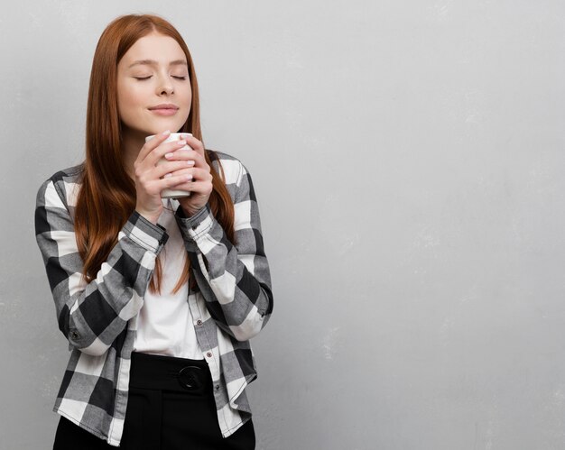 Woman holding mug copy space