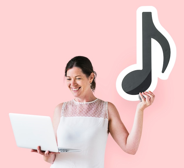 Woman holding a musical note and a laptop