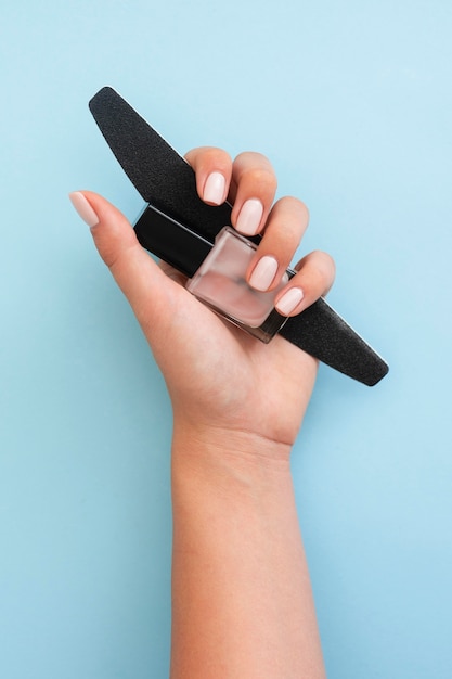 Woman holding nail care tools