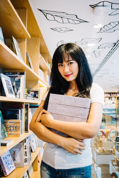 Woman holding notebook in library