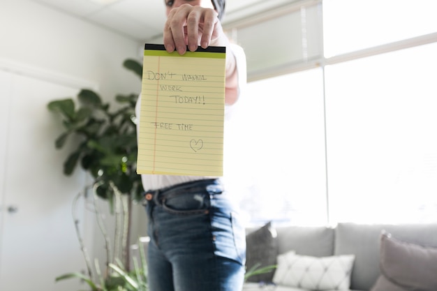 Woman holding notepad unwilling to work
