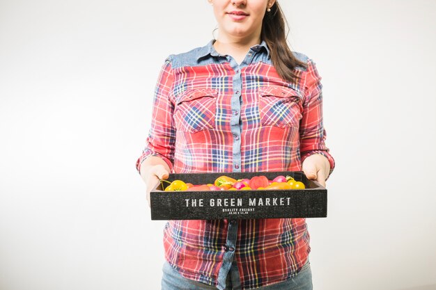 Woman holding pallet with tomatoes and peppers