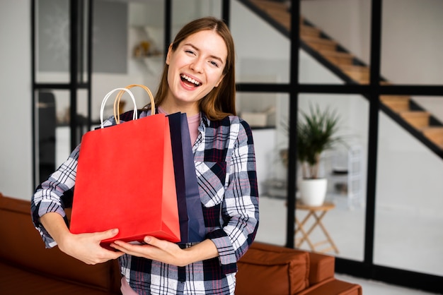 Woman holding paper bags and looking at camera