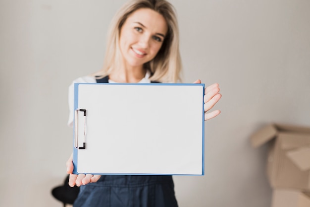 Woman holding paper clipboard with mock-up