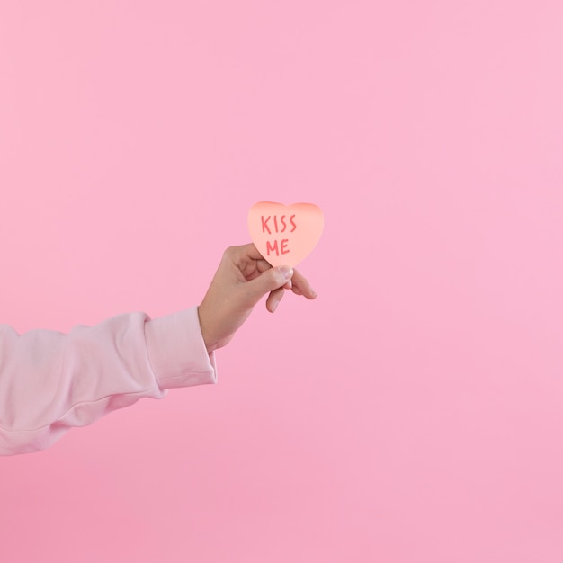 Woman holding paper decorative symbol of heart