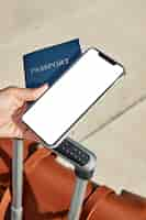 Free photo woman holding passport and smartphone with luggage at the airport during pandemic