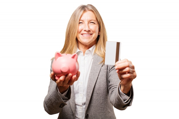 Free photo woman holding a pig piggy bank and a credit card