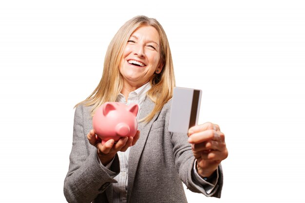 Woman holding pig piggy bank