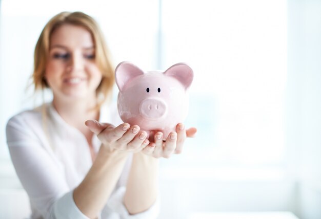 Woman holding a piggy bank