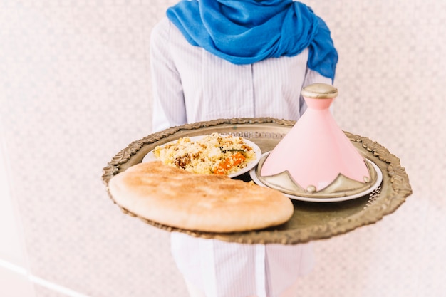 Woman holding plate of arab food