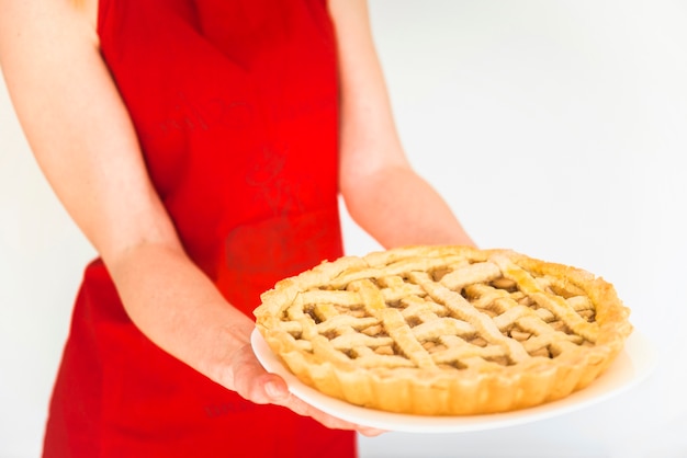 Free photo woman holding plate with apple pie