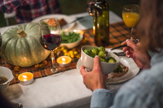 Woman holding plate with Brussels sprouts